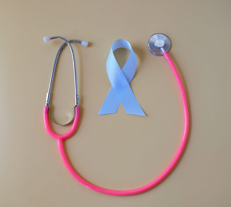 Blue ribbon and stethoscope on color background.の写真素材