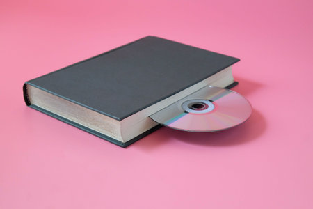 Compact disc in old book ,old and new technologies.の写真素材