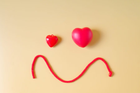 Red heart sign with red rope on color background.Valentines concept.の写真素材