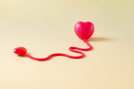 Red heart sign with red rope on color background.Valentines concept.