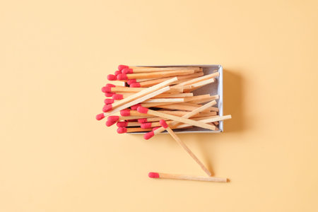 Set of new red head matchsticks in a cardboard box .