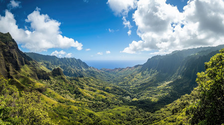 A breathtaking panoramic view of majestic mountains under a clear blue sky with lush greenery below. Copy space above.の素材