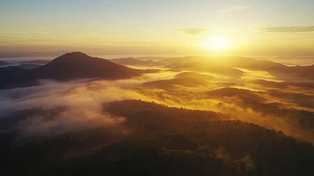 Stunning top view of a mountain range at sunrise, with misty valleys and soft golden light. Ample copy space in the sky."の素材