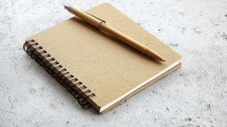 Recycled paper notebooks and pens made from bamboo, placed on a clean surface. Copy space.の素材