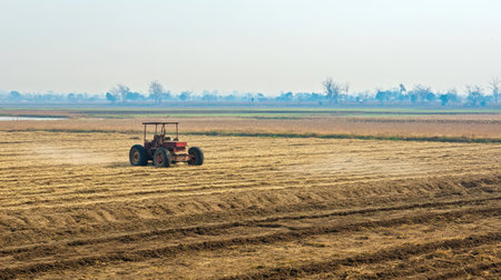 A South Asian agricultural power tiller on an empty field with copy space. No peopleの素材