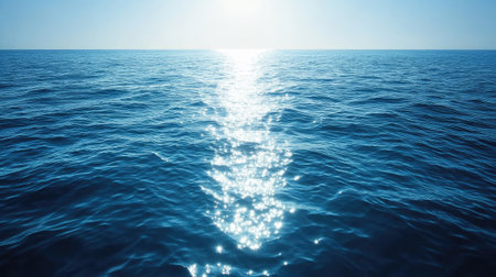 A top view of calm blue ocean waters with gentle ripples and sun reflections. Ample copy space on the upper side.の素材