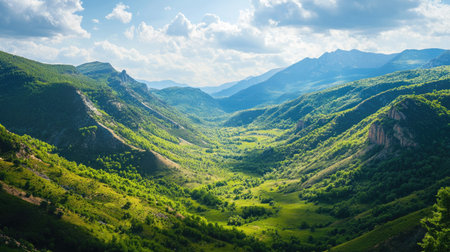 Bird's-eye view of a mountain valley in spring, with open sky for text or logosの素材