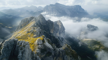 Bird's-eye view of a mountain range with dramatic cliffs, with ample sky space for textの素材