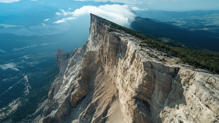 Overhead view of a mountain ridge with dramatic cliffs, with ample sky space for a messageの素材