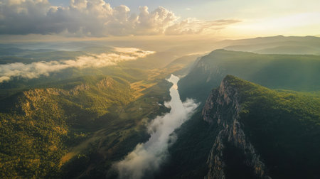 Aerial perspective of a mountain ridge with a river below, with open sky for a messageの素材