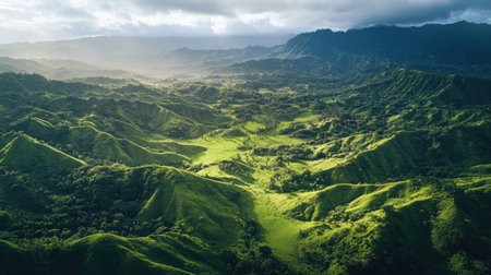 Overhead shot of a lush green valley nestled between mountain ridges with plenty of copy space in the skyの素材