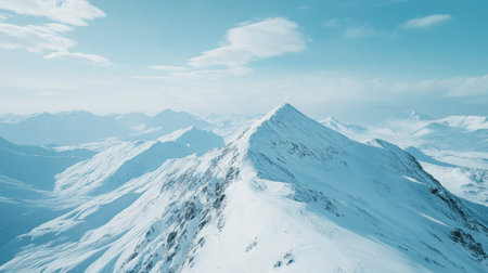 Overhead view of a snow-covered mountain with vast open sky, perfect for placing a headlineの素材