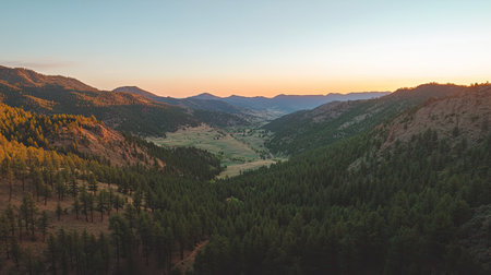 Overhead shot of a mountain valley at sunrise, with clear sky for copyの素材