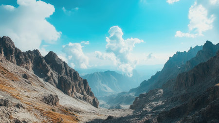 High-angle view of a rugged mountain terrain with a large expanse of sky, perfect for a headlineの素材