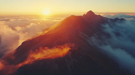 Top-down view of a dramatic mountain landscape at sunset, with ample space for text in the glowing skyの素材