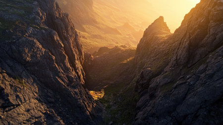 Top-down view of a dramatic mountain landscape at sunset, with ample space for text in the glowing skyの素材