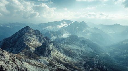 High-angle view of a rugged mountain terrain with a large expanse of sky, perfect for a headlineの素材