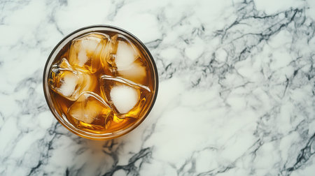 Cold brew coffee with ice cubes, placed on a marble table with room for copyの素材