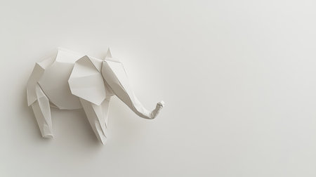 Minimalist top view of a white origami elephant on a neutral backdrop emphasizing clean lines. Copy space availableの素材