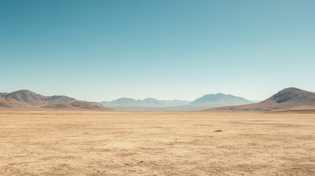 Dry desert landscape with distant mountains under a cloudless sky, room for text. No people, copy spaceの素材
