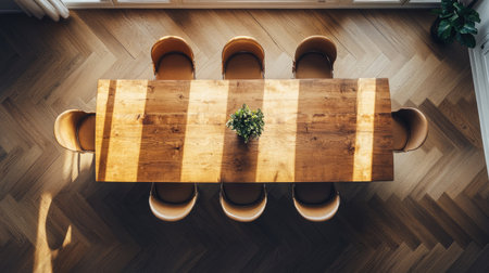 Elegant wooden dining table with modern chairs, shot from above with ample copy space.の素材