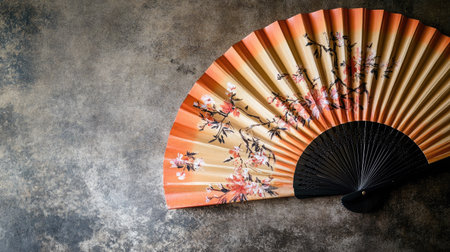 A close-up of a Chinese fan with delicate hand-painted designs. No people, copy space.の素材