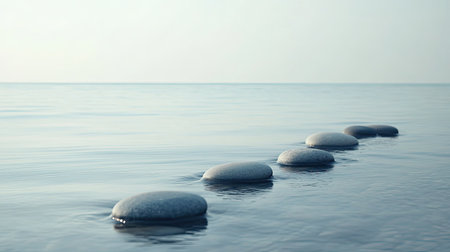 A calm ocean view with smooth stones arranged in a zen-like pattern on the shore. Space for text.の素材
