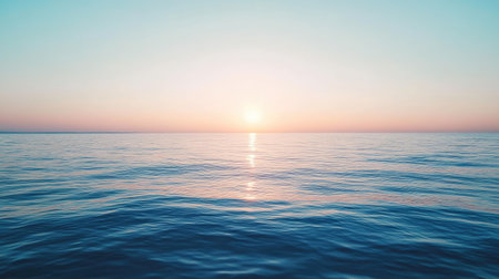 A calm sea with the sun setting in the distance, creating a perfect space for text. No people.の素材