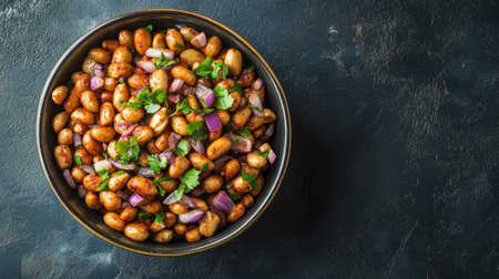 A bowl of spiced peanuts mixed with chopped onions and coriander, on a plain background with room for text.の素材