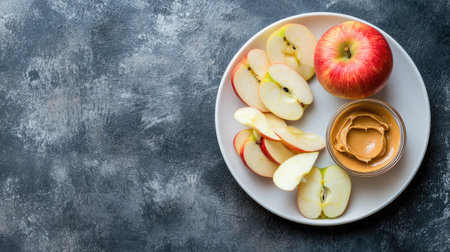 Enjoy a fresh red apple accompanied by sliced segments and smooth peanut butter dip, making it a perfect choice for healthy snacks and nutritious meal options.の素材