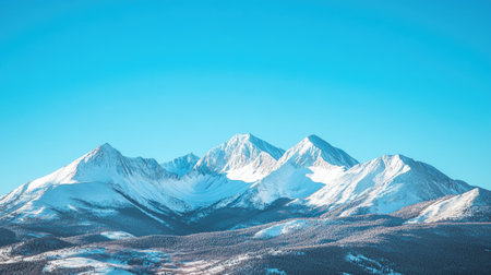 Rocky Mountains covered in snow, with plenty of room for text in the clear skyの素材