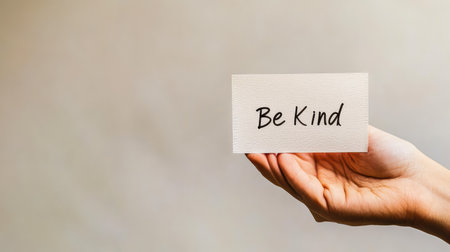 Handwritten note reading "Be Kind" on white background, perfect for World Kindness Day themes with copy spaceの素材