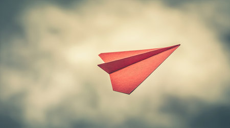 Paper airplane symbolizing ambition and goal-setting, neutral background, room for textの素材
