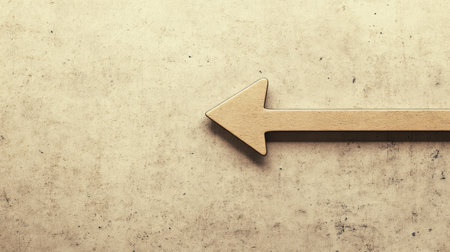 An elegant wooden arrow points left against a grunge textured background, perfect for design projects requiring directional elements and rustic charm. Ideal for various uses.の素材
