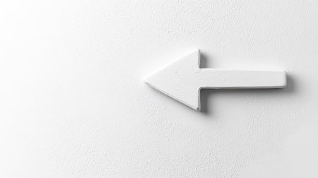 A minimalist white arrow on a textured wall, ideal for design projects. This image offers versatility for various creative applications and marketing communications.の素材