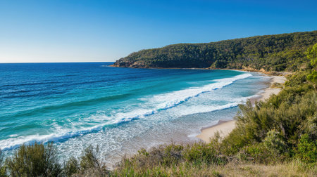 Experience the serene beauty of a tranquil beach landscape with gentle waves, lush green hills, and a clear blue sky, perfect for nature lovers and travelers.の素材