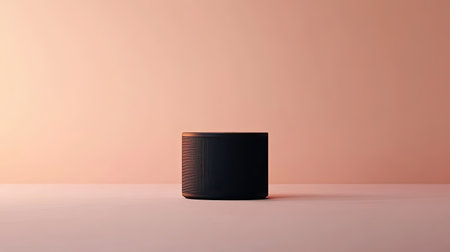 A sleek black speaker stands elegantly on a soft pink surface, combining modern design with a minimalist aesthetic, ideal for enhancing any contemporary interior space.の素材