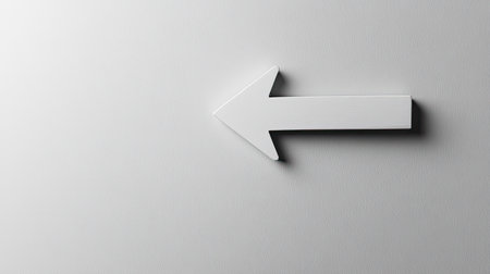 A clean and minimalistic image of a white arrow pointing left on a smooth background, perfect for conveying direction or used in various graphic design projects.の素材