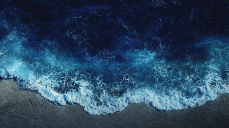 Discover a breathtaking aerial view of ocean waves gently crashing against a sandy shoreline, capturing the mesmerizing beauty of nature's coastal serenity.の素材
