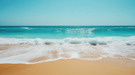 Experience the calming beauty of a sunlit beach with gentle waves lapping at the sandy shore, creating a serene atmosphere for relaxation and escape.の素材