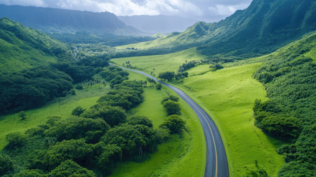 Experience breathtaking views of a winding road through a lush green valley, surrounded by majestic mountains under a cloudy sky, showcasing nature's beauty.の素材