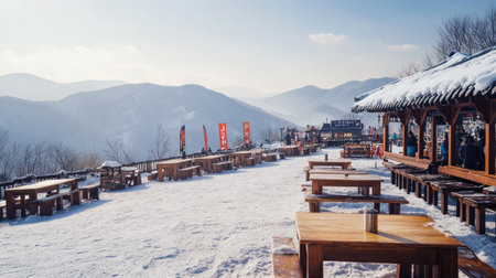 Captivating winter scene featuring empty wooden tables against a snowy mountain backdrop. Ideal for showcasing tranquility and natural beauty in cold environments.の素材