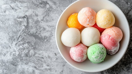 A delightful assortment of colorful mochi ice cream balls displayed in a white bowl. This visually appealing dessert offers a variety of flavors and textures, perfect for any sweet occasion.の素材