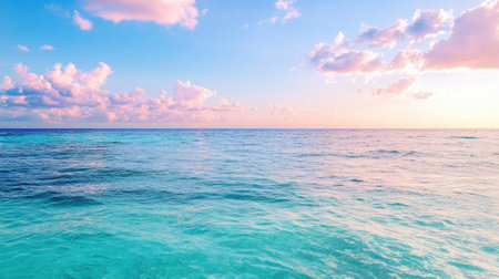 A stunning view of the endless ocean under a soft pastel sky. Gentle waves create a tranquil atmosphere, perfect for relaxation and inspiring travel dreams.の素材