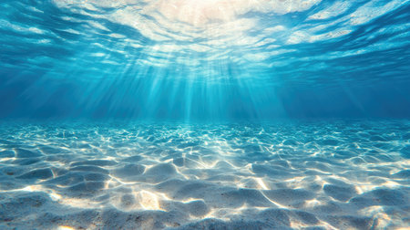 A stunning underwater scene showcasing the serene beauty of clear ocean water. Sunlight filters through, illuminating the sandy seabed. Perfect for aquatic themes.の素材