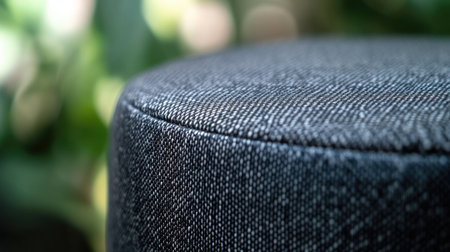 Close-up image showcasing the textured fabric of a round stool set against a blurred natural background, perfect for modern interior design inspiration.の素材