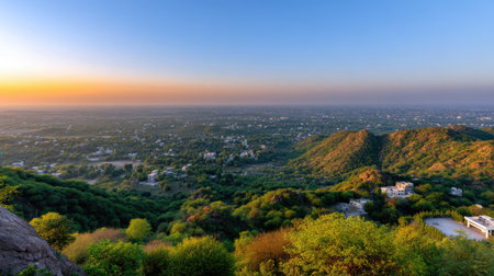 A breathtaking view showcasing the vibrant greenery and rolling hills from a high vantage point at dusk, perfect for capturing the essence of nature's beauty.の素材