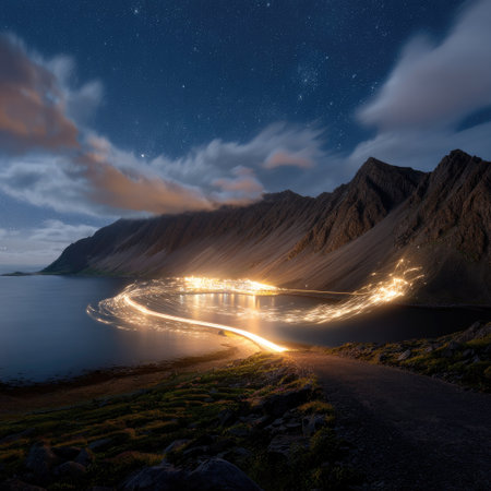 A captivating nightshot featuring a serene lake surrounded by majestic mountains, illuminated by shimmering lights against a starry sky.の素材