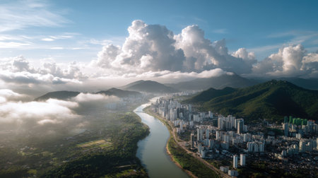 Stunning aerial view showcases a vibrant urban landscape featuring a winding river, lush mountains, and dramatic cloud formations, perfect for tourism.の素材