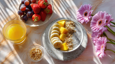 A vibrant breakfast scene featuring a colorful bowl of chia seeds topped with fresh fruits, vibrant flowers, and a glass of orange juice, perfect for a healthy start.の素材